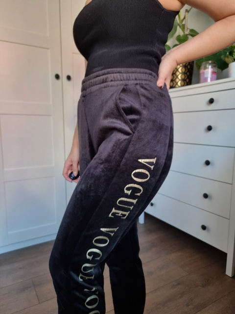 Black velour sweatpants with gold lettering