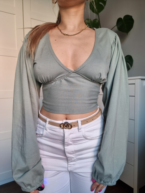 Pistachio feminine blouse with a necklace and an open back Pistachio feminine blouse with a necklace and an open back